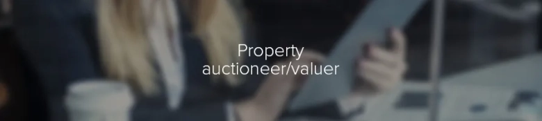Blurred image of a person holding a gavel at an auction with text overlay "Property auctioneer/valuer"