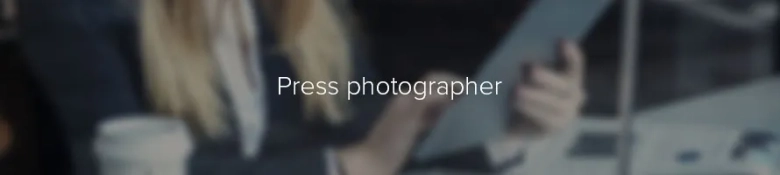 Blurred image of a person in an office setting with the text "Press photographer" overlayed.