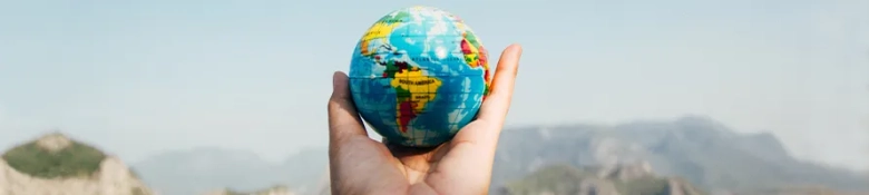 person holding a globe