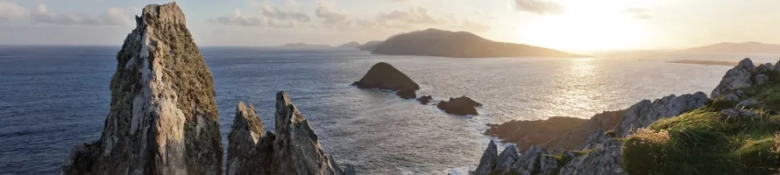 Sunset view over the rugged coastline of the Republic of Ireland with rocky outcrops and islands in the sea.