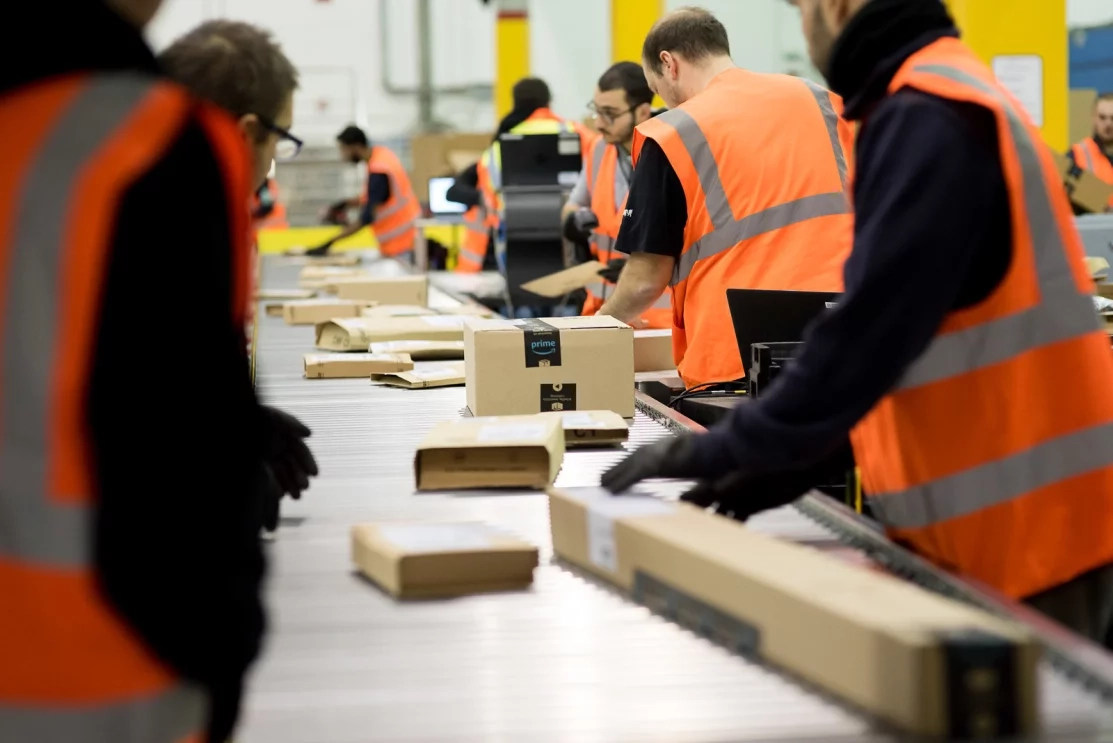 Amazon workers packing parcels