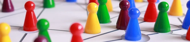 Board game pieces clustered together, representing networking