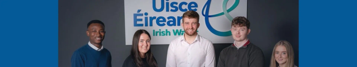 5 Uisce Eireann graduates standing in front of their logo