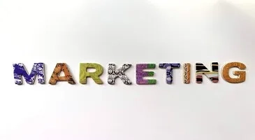 Stylized text spelling out the word 'MARKETING' with each letter featuring a different design or texture.