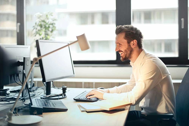 Smiling person using a computer