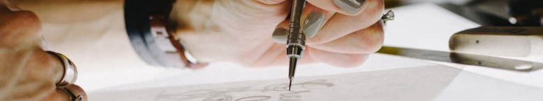 Creative person designing using a pen