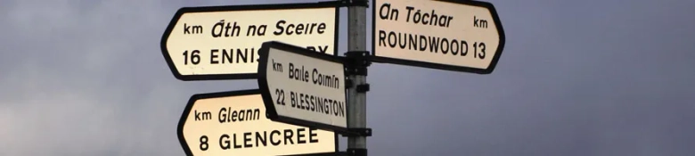 directions road sign in the irish language