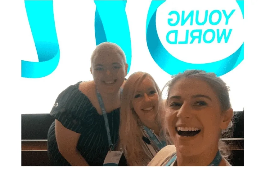 Three women smiling at event
