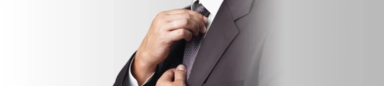 man in a suit fixing his tie